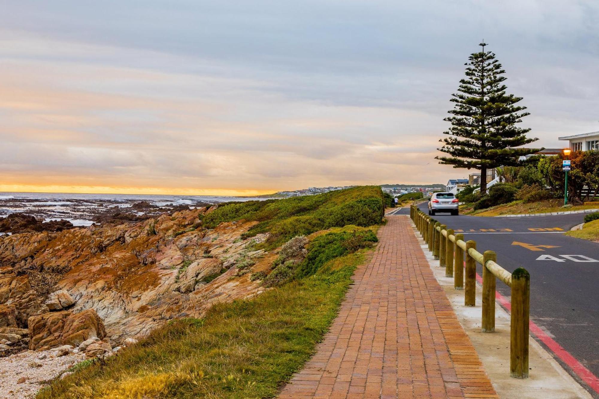 Hermanus coastal walkway at sunset with ocean views